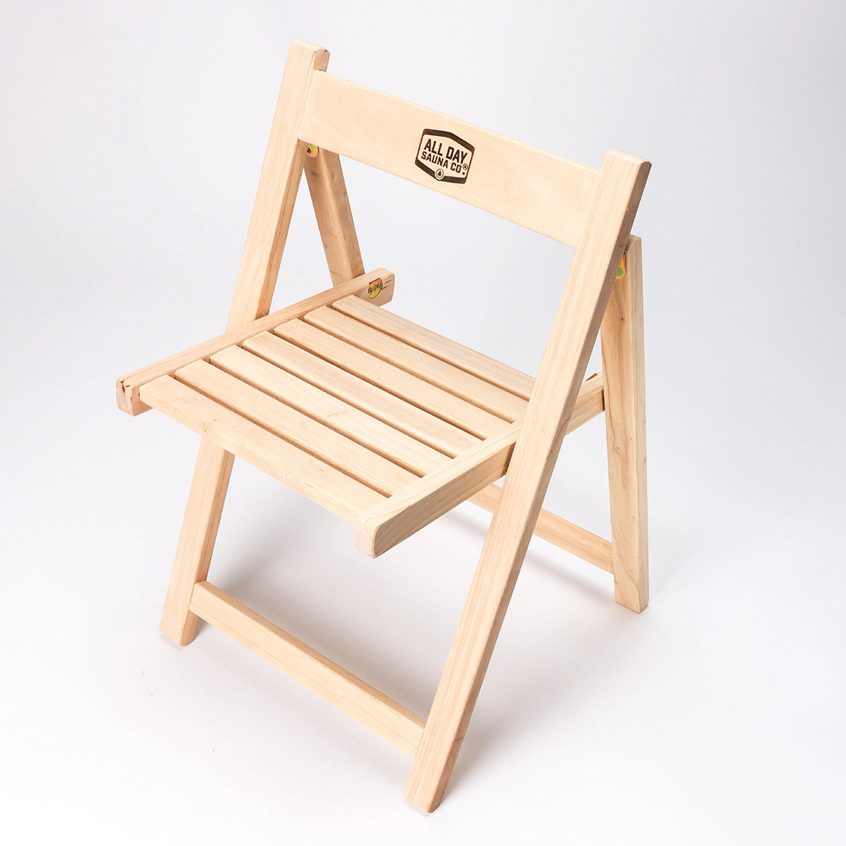 All Day Sauna Co. folding sauna chair — lightweight, portable wooden chair designed for comfortable sauna seating