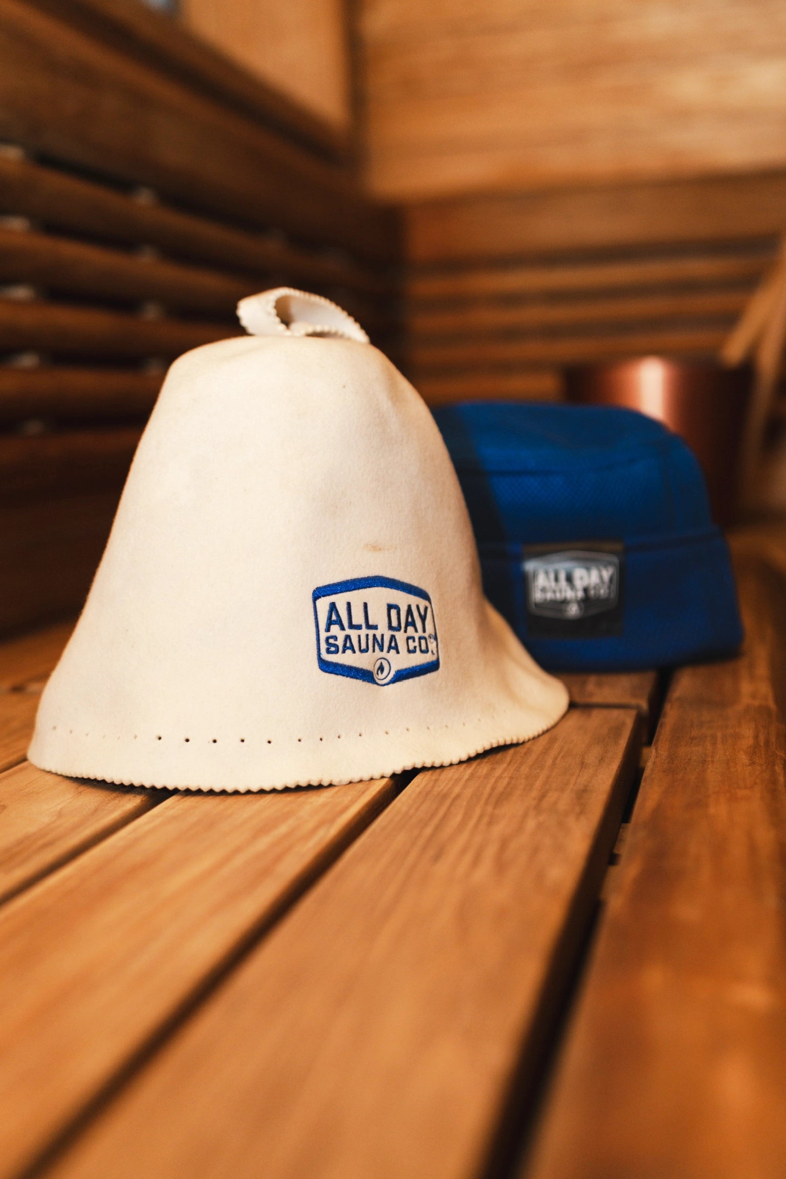 Wool sauna hat by All Day Sauna Co. in a traditional wood burning sauna.