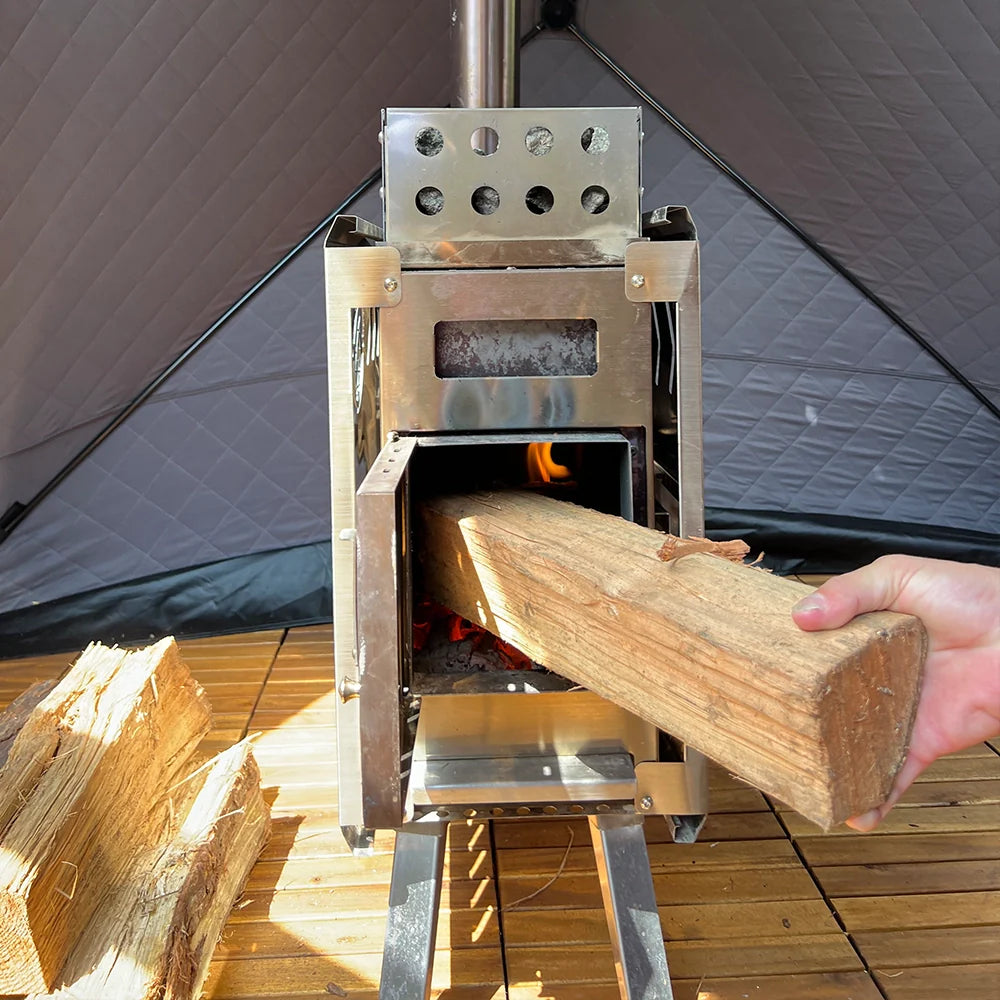 Person placing wood into stainless steel wood burning stove from All Day Sauna Co.