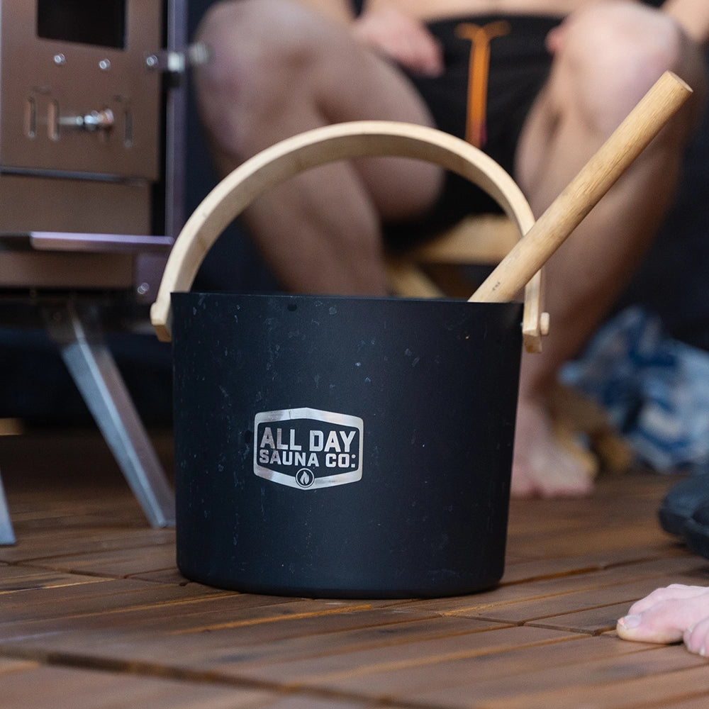 Close-up of All Day Sauna Co. water bucket and wooden ladle — designed for controlled steam infusion over sauna rocks