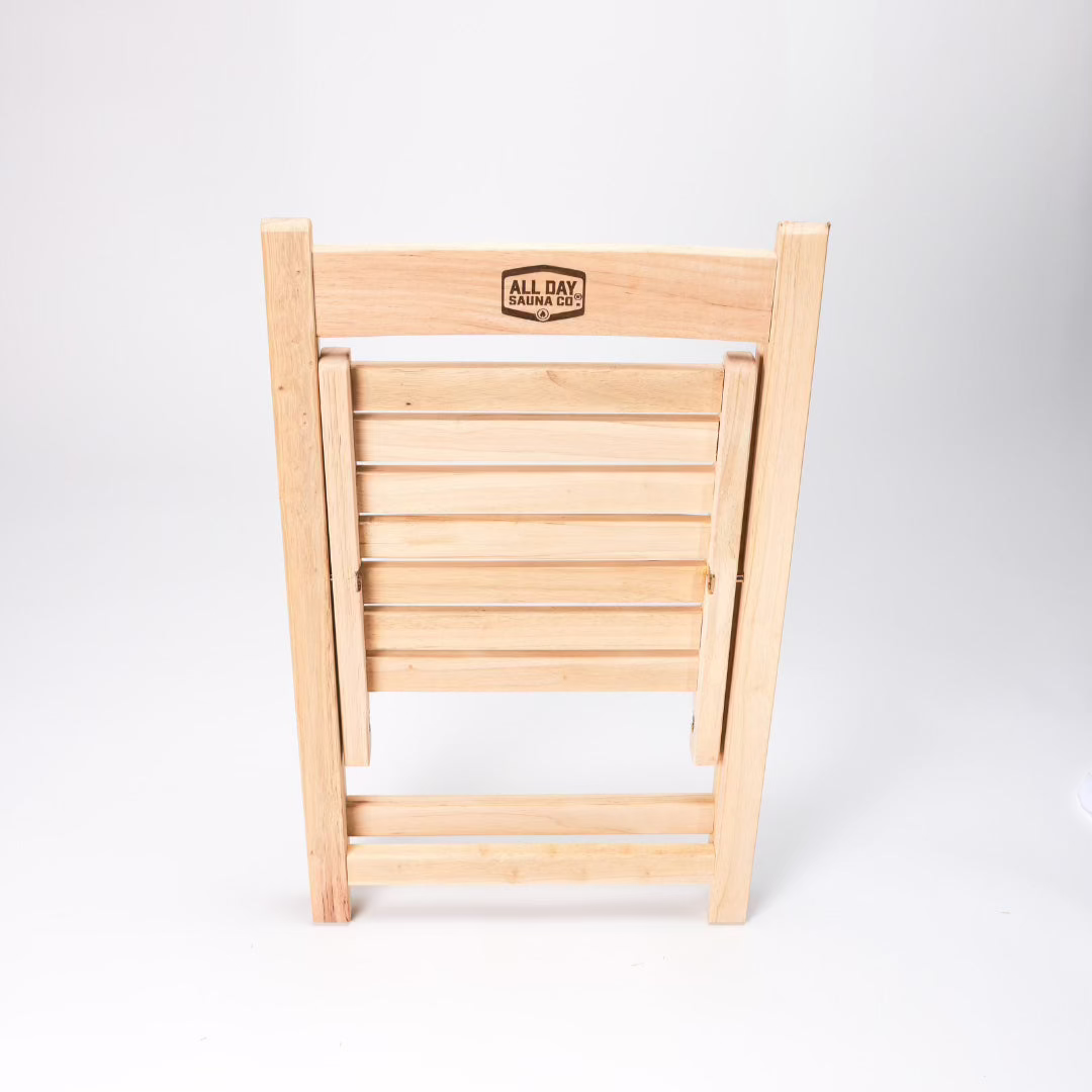All Day Sauna Co. folding sauna chair folded flat — space-saving design ideal for portable sauna setups