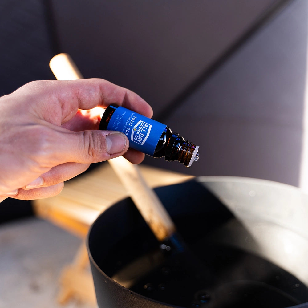 All Day Sauna Co. Smell Goods essential oils displayed next to sauna bucket and ladle — creating an elevated sauna experience