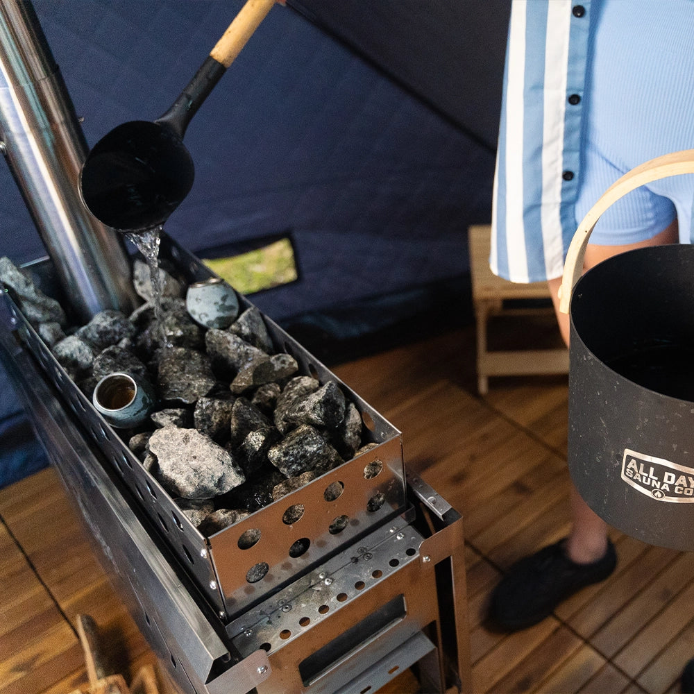 All Day Sauna Co. sauna rocks stacked on wood-burning stove — generating powerful steam during sauna session